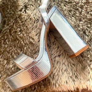 Metallic silver platform heels. Never worn. Nasty Gal.